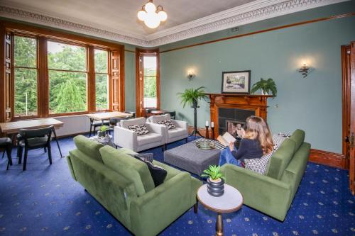 a woman sitting in a living room at Cluny Bank in Forres