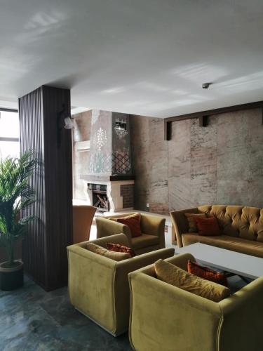 a living room with couches and a fireplace at Suhan Seaport Hotel in Kusadası