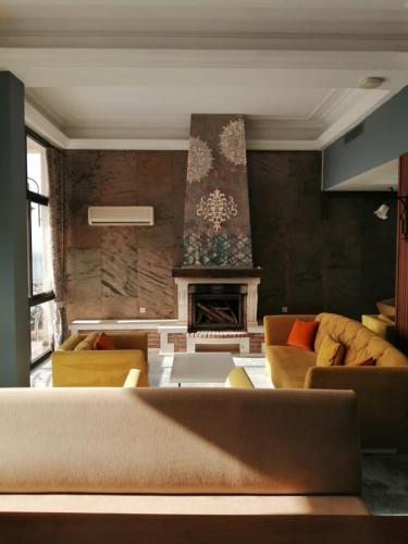 a living room with a couch and a fireplace at Suhan Seaport Hotel in Kusadası