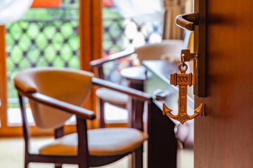 een kamer met stoelen en een deur met een sleutel bij Hotel Robert's Port in Mikołajki