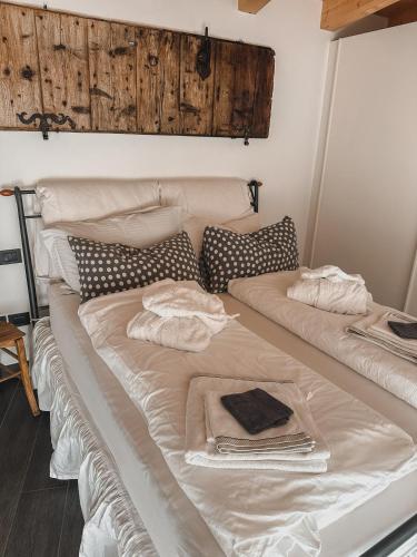 two beds with towels on top of them in a room at Relax in Pineta in Caldonazzo