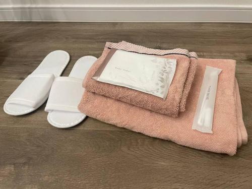 a pink towel sitting on top of a wooden floor at Permai Japon in Nikko