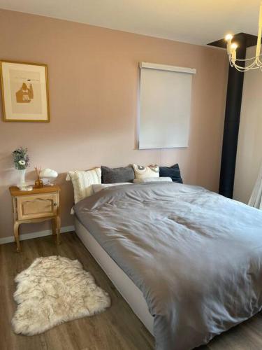 a bedroom with a large bed and a rug at Permai Japon in Nikko