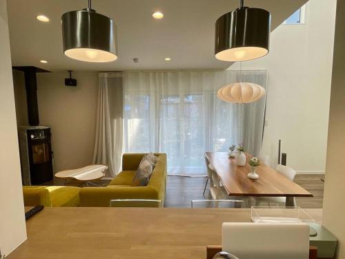 a living room with a couch and a table at Permai Japon in Nikko