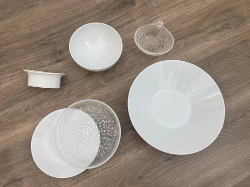 a group of white plates and bowls on a table at Permai Japon in Nikko