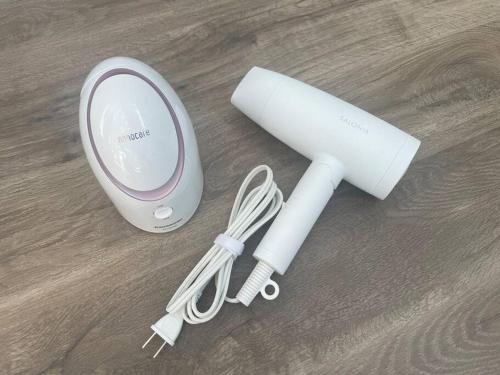 a white electric hair dryer sitting on a wooden floor at Permai Japon in Nikko