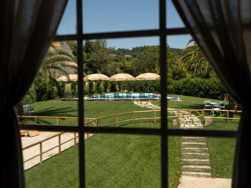 a view of a pool from a window at Quinta de Carcavelos Natures Home in Amarante