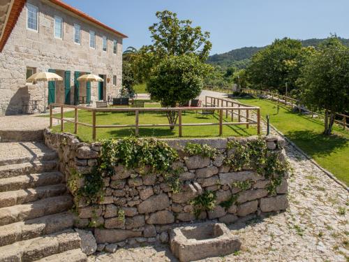 a stone wall in front of a building at Quinta de Carcavelos Natures Home in Amarante