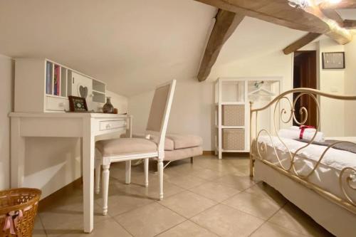 a bedroom with a desk and a bed and a table at La Torretta, Decameron View, sweet apartment in Certaldo