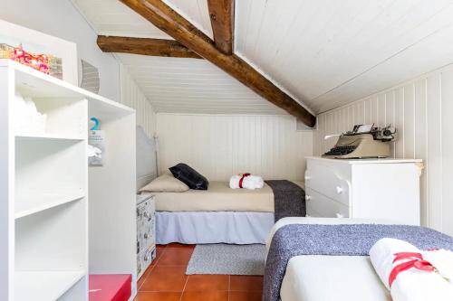 a room with two beds in a attic at La Torretta, Decameron View, sweet apartment in Certaldo