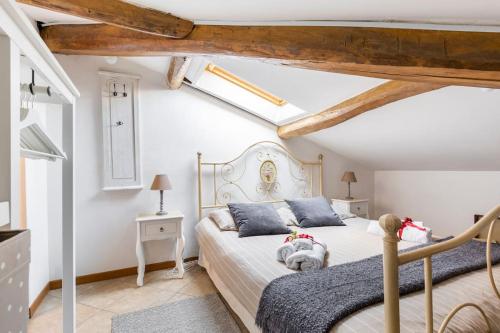 a bedroom with a bed with a teddy bear on it at La Torretta, Decameron View, sweet apartment in Certaldo