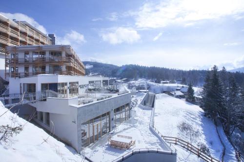 a building in the snow with snow covered ground at NIDUM - Casual Luxury Hotel in Seefeld in Tirol