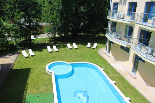 a swimming pool with a dolphin painted on it next to a building at Pop Art Hotel in Primorsko