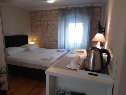 a small room with a bed and a tea kettle at Room No3 in Trogir