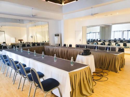 a large room with tables and chairs in it at Tamala Beach Resort in Kotu