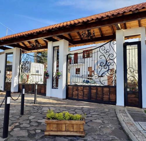 a house with a gate and a patio at Hotel Casa Francisca Mazamitla. in Mazamitla