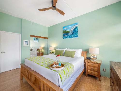 a bedroom with a large bed with a tray on it at Penthouse With Fabulous Ocean View Near Waikiki Beach in Honolulu