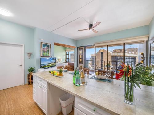 a kitchen with a counter with a view of a living room at Penthouse With Fabulous Ocean View Near Waikiki Beach in Honolulu