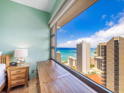 a bedroom with a large window with a view of the ocean at Penthouse With Fabulous Ocean View Near Waikiki Beach in Honolulu