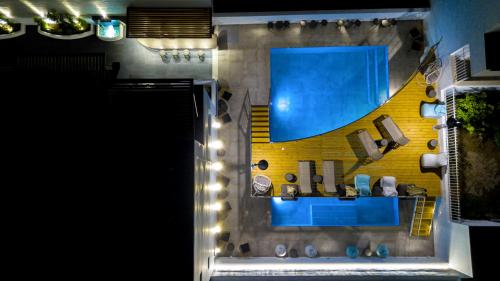 an overhead view of a bathroom with a swimming pool at Deluxe Hotel Santorini in Fira