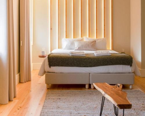 a bedroom with a bed with a large window at Quinta de Carcavelos Natures Home in Amarante