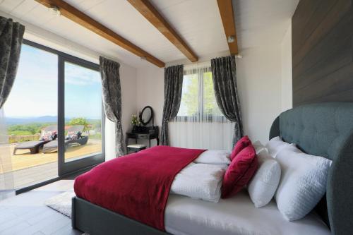 a bedroom with a bed and a large window at Lotti Residence Exclusiv in Balatonfüred