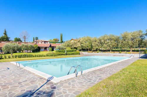 a swimming pool in the middle of a yard at Residence Elena 19-B by Wonderful Italy in Soiano del Lago