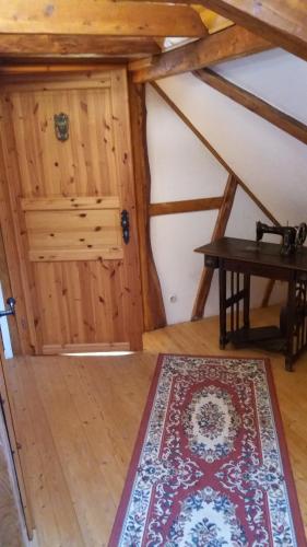 an attic room with a table and a rug at Haan-Ferienwohnung in Haan