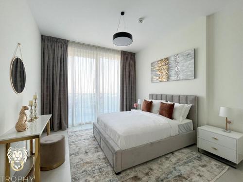 a bedroom with a bed and a large window at Luxury 1BR Apt with Unobstructed Dubai Frame View in Dubai