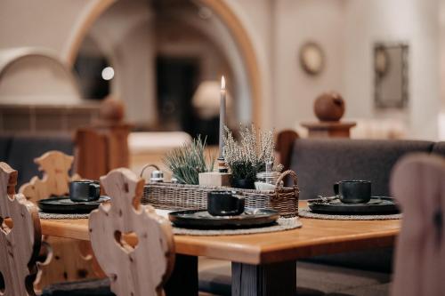 a wooden table with plates and cups on it at Alpenappartements Cristall in Ehrwald