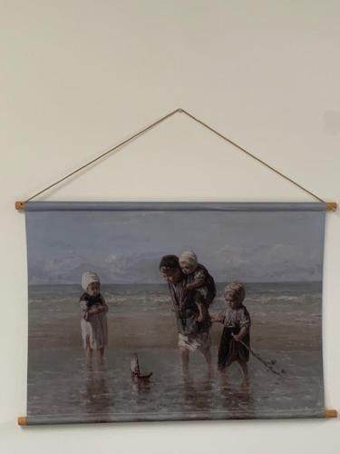 a framed picture of people on the beach at Appartement 't Loft in Zandvoort