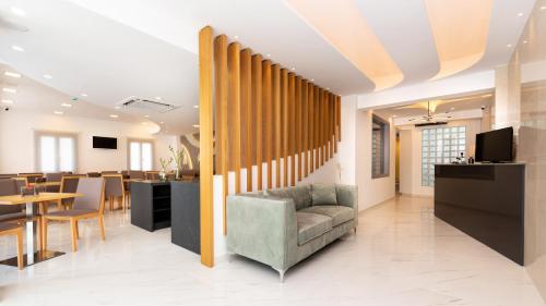 a waiting room with a chair and a table at Deluxe Suites Santorini in Fira