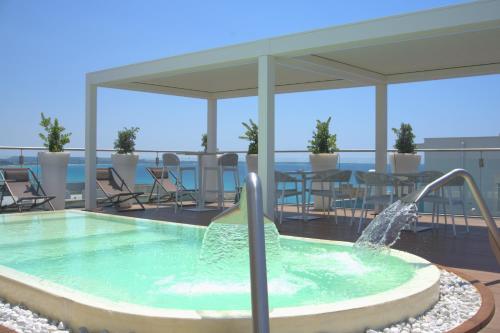 a swimming pool with a fountain on top of a building at M&F Hotel in Gallipoli