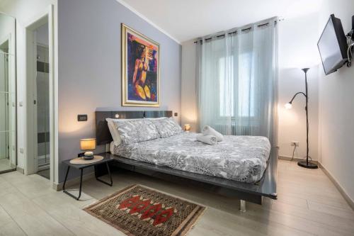a bedroom with a bed and a table in it at La Terrazza di Como in Como