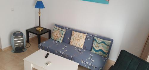 a living room with a blue couch with pillows at Apartamento Ciudad de las Ciencias in Valencia