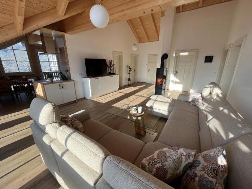 a living room with a couch and a table at Ferienwohnung Blick Thyratal Obergeschoss in Stolberg i. Harz