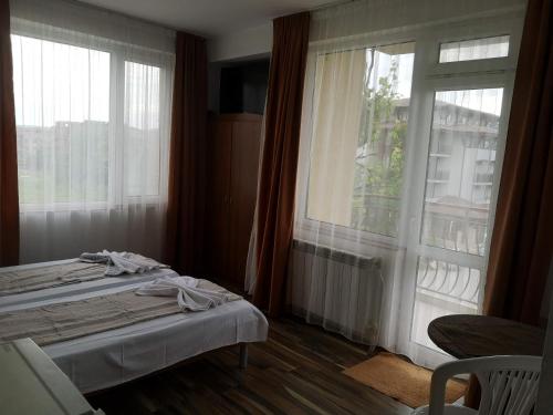 um quarto com uma cama e uma grande janela em Miraj-MD em Primorsko