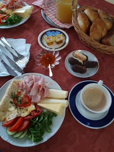 a table with plates of food and a bowl of soup at Hotel U Beránků in Libochovice