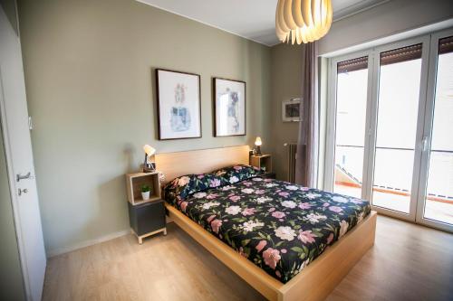 a bedroom with a bed with a floral bedspread at Chic and Freak Atelier in Como