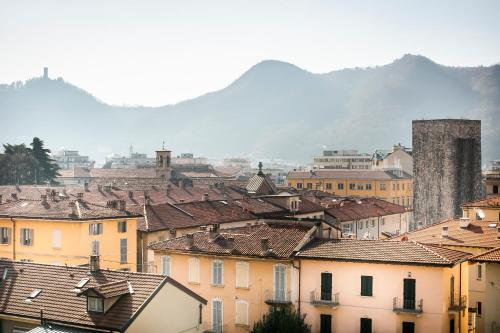 a city with buildings and mountains in the background at Chic and Freak Atelier in Como