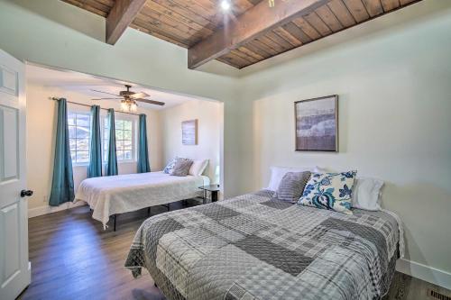 a bedroom with two beds and a ceiling at Relaxing Lake Arrowhead Home about 1 Mi to Lake! in Lake Arrowhead