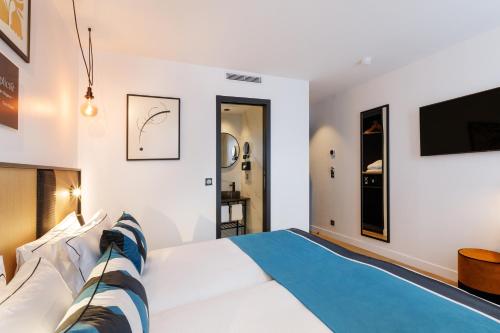 a bedroom with a large bed and a tv at Star Champs-Elysées in Paris