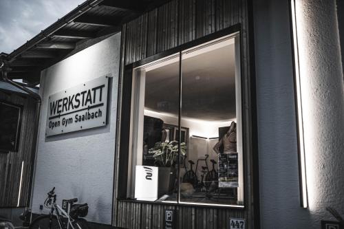 a window of a store with a sign on it at Grand Pension Franziska - inkl CrossFit Gym in Saalbach Hinterglemm