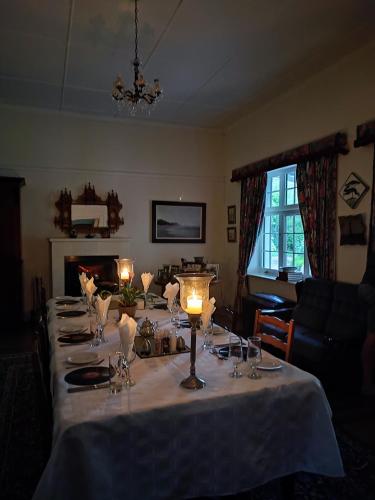 a table with candles on it in a living room at Ganora Guest Farm, Camping and Excursions in Nieu-Bethesda