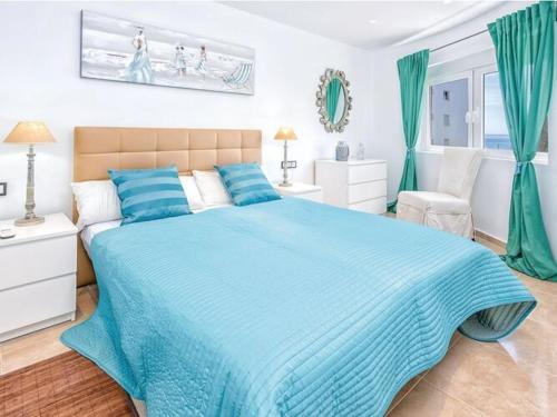 a bedroom with a blue bed with a blue blanket at Charming apartment in Mijas in Mijas