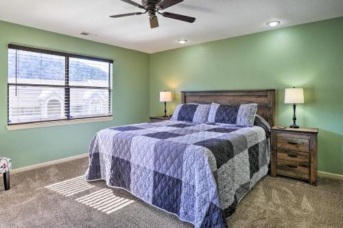 a bedroom with green walls and a bed and a window at Branson Getaway - 10 Mi to Silver Dollar City! in Branson
