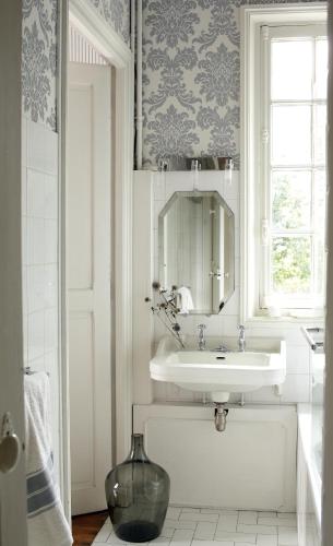 une salle de bain blanche avec un lavabo et un miroir dans l'établissement Villa du Châtelet, à Choisy-au-Bac