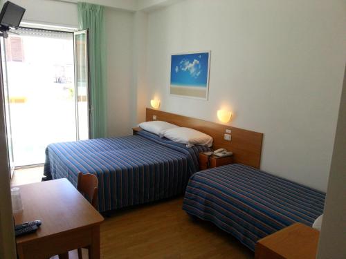 Postel nebo postele na pokoji v ubytování Hotel Mayor