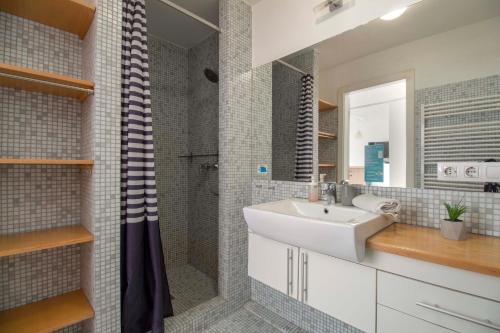 a bathroom with a sink and a shower at Star Apartments with free parking in Budapest