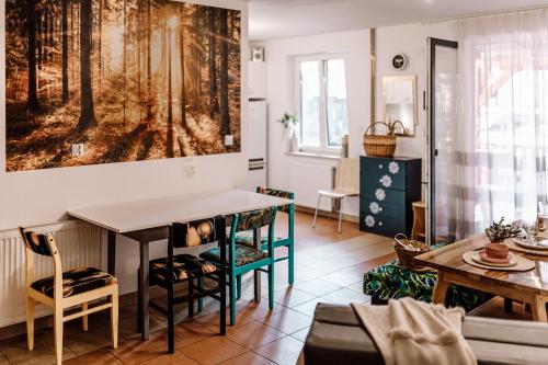 a living room with a table and chairs at Domki RADAWA na Kliszówce in Radawa